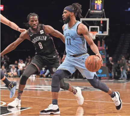  ?? BRAD PENNER-USA TODAY SPORTS ?? Memphis Grizzlies point guard Mike Conley (11) controls the ball against Brooklyn Nets small forward DeMarre Carroll (9) on Friday.