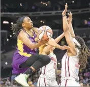  ?? Meg Oliphant Getty Images ?? NNEKA OGWUMIKE of the Sparks drives in the first half against Myisha Hines-Allen of the Mystics.