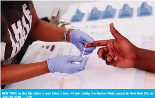  ??  ?? NEW YORK: In this file photo a man takes a free HIV test during the Harlem Pride parade in New York City on June 29, 2019. — AFP