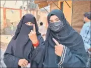  ?? HT ?? Two voters showing their inked fingers at a polling booth in AMU City Girls’ High School in Aligarh.