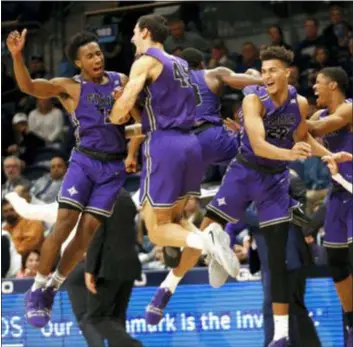  ?? LAURENCE KESTERSON — THE ASSOCIATED PRESS ?? Furman’s Alex Hunter (10) and Clay Mounce (45) celebrate after the Paladins stunned defending national champion Villanova, 76-68, in overtime on Saturday.