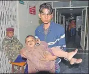  ??  ?? A child injured by manjha being taken for treatment in Jaipur.
HT FILE