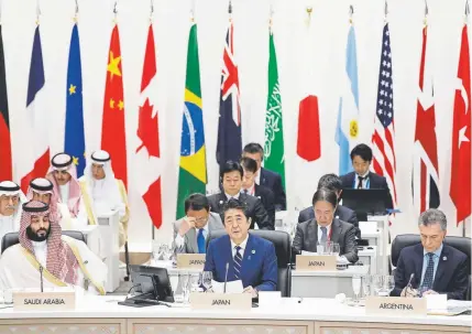  ?? Kiyoshi Ota, Bloomberg News ?? Japanese Prime Minister Shinzo Abe speaks Friday while Saudi Crown Prince Mohammed bin Salman and Argentina’s President Mauricio Macri listen during a working lunch at the Group of Twenty nations summit in Osaka, Japan. “A free and open economy is the basis for peace and prosperity,” Abe said. The summit continues Saturday.