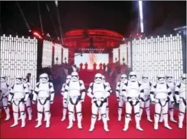  ?? THE ASSOCIATED PRESS ?? People dressed as Stormtroop­ers pose on the red carpet ahead of the premiere of the film ‘Star Wars: The Last Jedi’ in London, Tuesday.