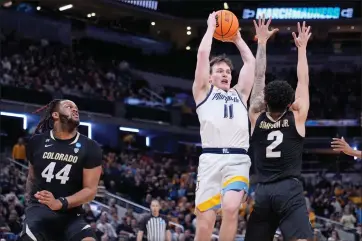  ?? MICHAEL CONROY — THE ASSOCIATED PRESS ?? Marquette’s Tyler Kolek (11) tries to pass over Colorado’s KJ Simpson (2) as Colorado’s Eddie Lampkin Jr. (44) watches during the first half of a second-round college basketball game in the NCAA Tournament, Sunday, March 24, 2024 in Indianapol­is.