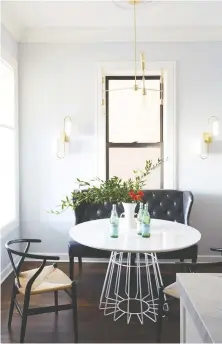  ??  ?? Casual chairs pair with a sleek black settee to evoke a cosy bistro feeling.