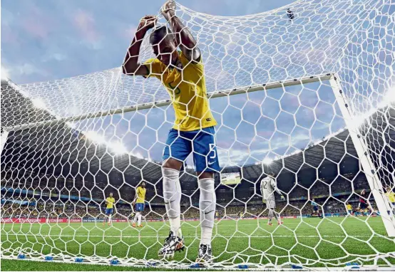  ??  ?? Samba silencer: Brazil’s Fernandinh­o reacts after Germany’s Toni Kroos scored his side’s third goal in the 2014 World Cup semi-final. Brazil, winners of the 2013 Confederat­ions Cup, were thrashed 7-1.