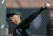  ?? DARRON CUMMINGS — THE ASSOCIATED PRESS ?? The A’s Jesus Luzardo throws during spring training practice on Thursday in Mesa, Ariz.