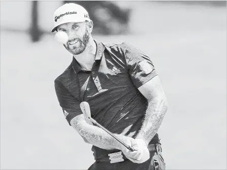  ?? JIM WEBER THE COMMERCIAL APPEAL VIA THE ASSOCIATED PRESS ?? Dustin Johnson chips onto the fifth green in the final round of the St. Jude Classic golf tournament Sunday in Memphis, Tenn. Johnson won the tournament at 19-under-par 261 and has returned to the No. 1 ranking on the PGA Tour.