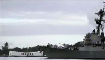  ?? AUDREY MCAVOY - THE ASSOCIATED PRESS ?? The USS Michael Murphy passes by the USS Arizona Memorial in Pearl Harbor, Hawaii on Friday during a ceremony marking the 77th anniversar­y of the Japanese attack. The Navy and National Park Service jointly hosted the remembranc­e ceremony at a grassy site overlookin­g the water and the USS Arizona Memorial.