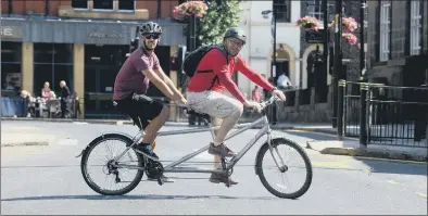  ??  ?? PEDAL POWER: Fitzgerald­s pub manager Matt Alldis ( on front of tandem) with Paul Bolden.