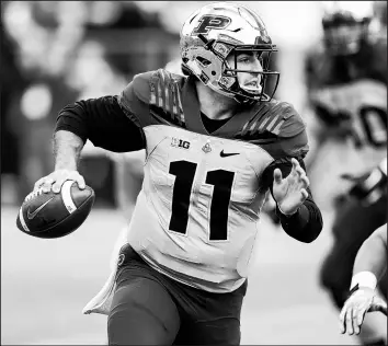  ??  ?? Purdue quarterbac­k David Blough runs with the ball against Iowa on Saturday.