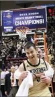  ?? KATHY KMONICEK — THE ASSOCIA’TED PRESS ?? Wofford guard Fletcher Magee (3) receives a hug after his team defeated UNC-Greensboro for the Southern Conference tournament championsh­ip. The Terriers face Seton Hall in the first round.