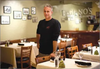  ??  ?? Mark Viggiano, owner of Viggiano's Italian BYOB, poses for a portrait May 29 in Conshohock­en, Pa. Viggiano lost his restaurant during the recession and reopened it about a year ago.