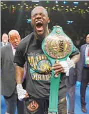  ?? Al Bello Getty Images ?? DEONTAY WILDER celebrates with his belt after knocking out Dominic Breazeale in the first round.