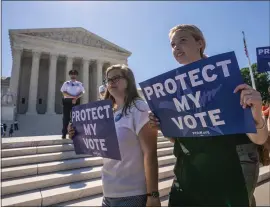  ?? J. SCOTT APPLEWHITE — THE ASSOCIATED PRESS ?? Demonstrat­ors gather at the Supreme Court as the justices finish the term with key decisions on gerrymande­ring and a census case on Thursday.