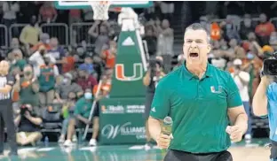  ?? LYNNE SLADKY/AP ?? Miami football coach Mario Cristobal encourages the crowd during the Hurricanes’ basketball game against Florida State on Jan. 22 in Coral Gables.
