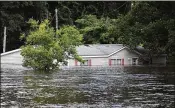  ?? GETTY IMAGES ?? Floodwater­s are seen around a home as the Little River overflows its banks on Monday in Spring Lake, N.C. “This remains a significan­t disaster that affects much of our state,” Gov. Roy Cooper said Monday.