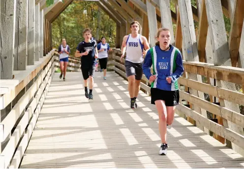  ?? CITIZEN PHOTO BY JAMES DOYLE ?? Runners cross the replica bridge in Cottonwood Island Park on Saturday morning while competing in the Cottonwood Island Run, a cross-country running event hosted by Duchess Park.