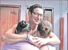  ??  ?? Honduran Jefferson Padilla (centre), who was arrested after the protests that began last April against the government, embraces his wife (eft) and mother-in-law in Managua. — AFP photo