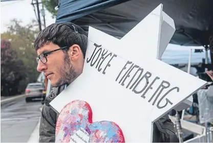  ?? Picture: Shuttersto­ck. ?? A mourner with a star bearing Joyce’s name outside the Pittsburgh synagogue.