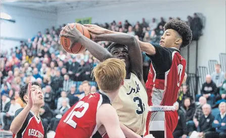  ?? JULIE JOCSAK THE ST. CATHARINES STANDARD ?? Notre Dame’s Shammar Campbell, with the ball, is double teamed by Governor Simcoe’s Mitch McPherson and Darren Johnston.