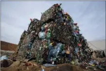  ?? THE ASSOCIATED PRESS ?? Plastic trash is compacted into bales ready for further processing at the waste processing dump on the outskirts of Minsk, Belarus. A new massive study finds that production of plastic and the hardto-breakdown synthetic waste is soaring in huge...