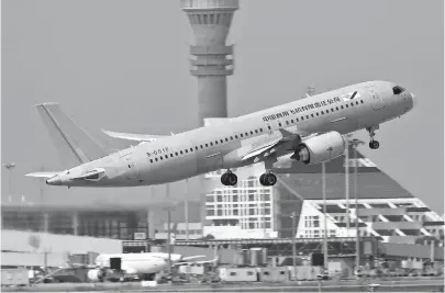  ??  ?? The No. 105 C919 takes off from the Pudong airport at 10am yesterday on a test flight. — Ti Gong