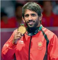  ?? AFP ?? India’s Bajrang Punia battled past Japan’s Daichi Takatini 11-8 in a hard-fought final in Jakarta on Sunday. —