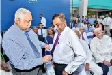  ??  ?? Aitken Spence Chairman pinning 150th anniversar­y pin on Deputy Chairman and Managing Director