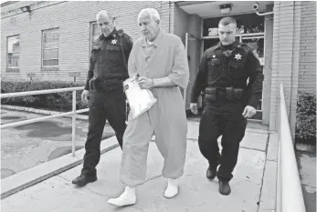  ?? GENE J. PUSKAR, AP ?? Former Penn State assistant football coach Jerry Sandusky, center, leaves the Centre County Courthouse in Bellefonte, Pa., last May after a hearing involving his request for a new trial.