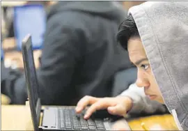  ?? Patrick T. Fallon For The Times ?? THOMAS NAVAS studies a computer screen during his Introducti­on to Data Science class, in which students learn data collection and computer programmin­g.