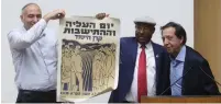  ?? (Marc Israel Sellem/The Jerusalem Post) ?? MARC EISENBERG (right), from the French olim organizati­on Qualita, gives an original poster from 1950 to MK Avraham Neguise (center) at the Knesset yesterday. MK Moti Yogev helps display the poster, which says ‘Aliya and Settlement Day – Keren Hayesod.’