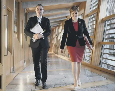  ??  ?? 0 Finance Secretary Derek Mackay has Nicola Sturgeon for company as he prepares to deliver his budget speech