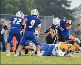  ??  ?? Orland’s Grant Foster looks for running room during the Trojans’ game against Pierce.