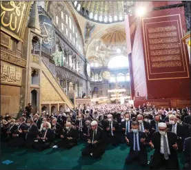  ?? (AP/Turkish Presidency) ?? Turkish President Recep Tayyip Erdogan (center) on Friday takes part in the first Muslim prayers in 86 years at the historic Hagia Sophia in Istanbul.