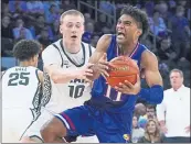  ?? FRANK FRANKLIN II — THE ASSOCIATED PRESS ?? Kansas’ Remy Martin protects the ball from Michigan State’s Joey Hauser (10) during the second half of Tuesday’s game in New York. Kansas won, 87-74.