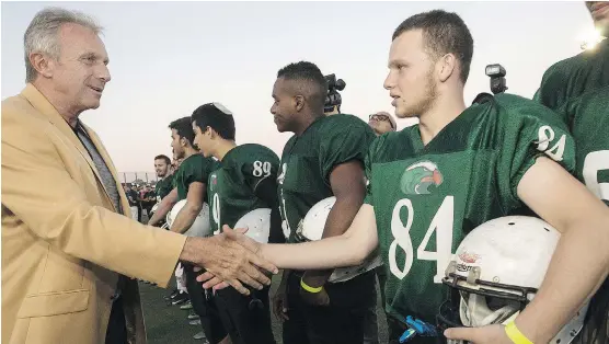  ?? THE ASSOCIATED PRESS ?? NFL Hall of Famer Joe Montana shakes hands with an Israeli player near Tel Aviv. Eighteen of the NFL’s best are in the Holy Land promoting the sport.