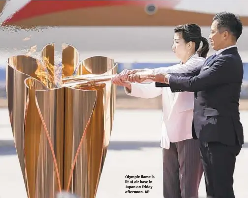  ??  ?? Olympic flame is lit at air base in Japan on Friday afternoon. AP