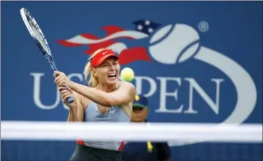  ?? JASON DECROW - THE ASSOCIATED PRESS ?? In this Aug. 27, 2014, file photo, Maria Sharapova, of Russia, returns a shot to Alexandra Dulgheru, of Romania, during the second round of the U.S. Open tennis tournament, in New York. Sharapova has been granted a wild-card invitation for the U.S....