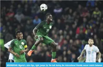  ??  ?? KRASNODAR: Nigeria’s John Ogu, right, jumps for the ball during the internatio­nal friendly soccer match between Argentina and Nigeria in Krasnodar, Russia. — AP