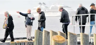  ?? KATHY JOHNSON ?? Passengers from the cruise ship MV Seabourn Quest disembark to spend the day in Shelburne during the ship’s port of call in 2019.