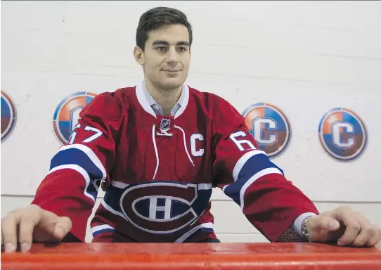  ?? JOHN KENNEY/MONTREAL GAZETTE ?? Max Pacioretty dons a vintage-style Montreal Canadiens jersey at a news conference on Friday where he was announced as the new team captain.