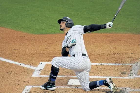  ?? David Zalubowski, The Associated Press ?? Colorado‘ s Nolan Arenado follows the flight of his foul ball hit off San Diego starting pitcher Zach Davies Friday at Coors Field.