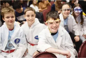  ?? DAX MELMER ?? Students from Holy Cross Catholic School, from left, Jon Aliko, 13, Michael Dunne, 12, Matthew Tracey, 12, Delaney Sloan, 12, and Felicia Rice, came dressed in NASA gear with space goggles for a speech by Dr. Roberta Bondar.
