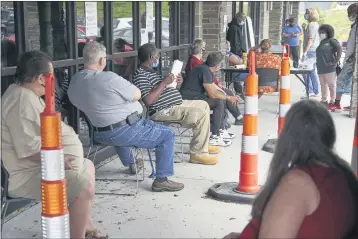  ?? NATI HARNIK — THE ASSOCIATED PRESS ?? Job seekers exercise social distancing as they wait to be called into the Heartland Workforce Solutions office in Omaha, Neb., Wednesday.