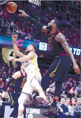  ??  ?? STRONG DEFENSE. Cleveland Cavaliers’ LeBron James blocks Golden State Warrior’s Stephen Curry in the second half of the game.