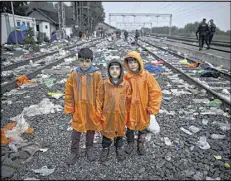  ?? ASSOCIATED PRESS ?? Syrian refugee brothers ranging in age from 6 to 10 wait for a train in Tovarnik, Croatia, to take them and their father to Germany to join their sister and mother who fled Syria a month earlier.