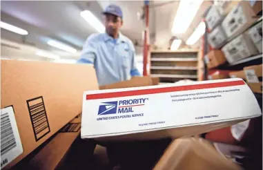  ?? DAVID GOLDMAN/AP ?? Packages pile up for sorting at a post office in Atlanta.