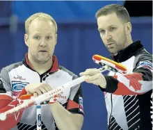  ?? DAVID BLOOM/POSTMEDIA NETWORK ?? Team Canada third Mark Nichols (left) and skip Brad Gushue discuss a shot during a World Men’s Curling Edmonton 2017 game against Team Italy on Thursday.